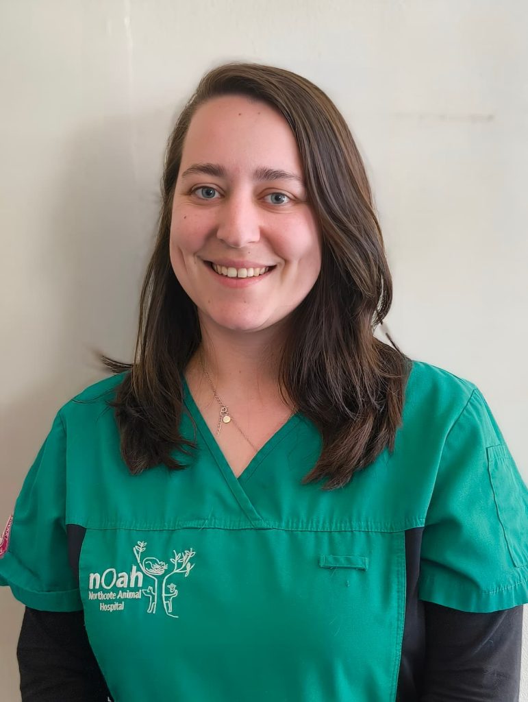 Dani Zahariadis smiling in green scrubs