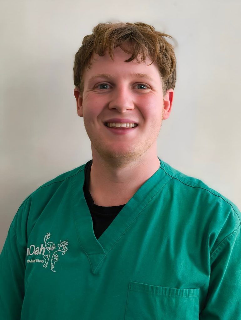 Rory Scobbie smiling in green vet uniform